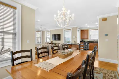 a dining room and kitchen with a table and chairs at Palms and Pines in Rosemary Beach