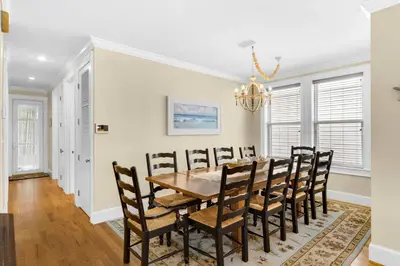 a dining room with a table and chairs at Palms and Pines in Rosemary Beach
