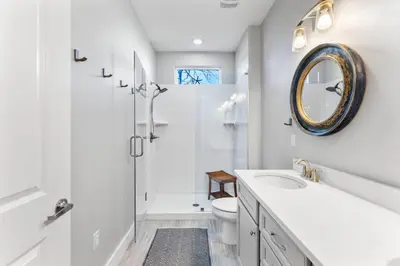 a white bathroom with a sink and a mirror at Saltwater Sanctuary in Santa Rosa Beach