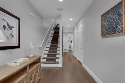 a hallway with a staircase in a house at Saltwater Sanctuary in Santa Rosa Beach
