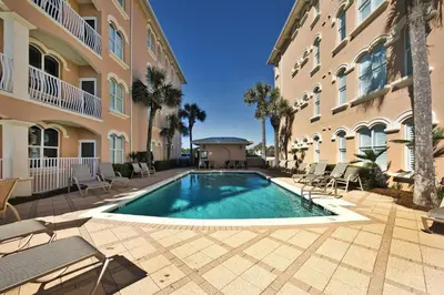 a swimming pool in the courtyard of a building at Monterey B-102 in Seacrest