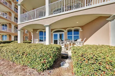 a house with a balcony and bushes in front of it at Monterey B-102 in Seacrest