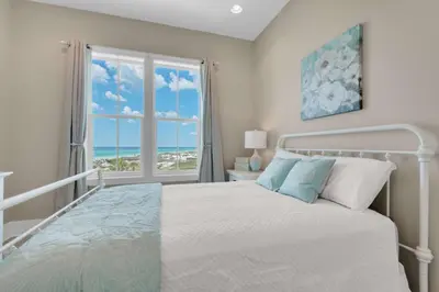 a bedroom with a bed with a view of the ocean at La Dolce Beacha in Inlet Beach
