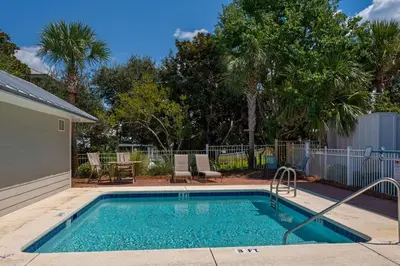 a small swimming pool in a yard with trees at La Dolce Beacha in Inlet Beach