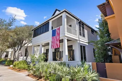 an american flag flies in front of a house at Abba Cottage in Rosemary Beach