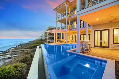 a house with a swimming pool next to the ocean at Del mar 30A in Seacrest