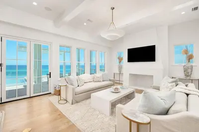 a living room with white furniture and a view of the ocean at Del mar 30A in Seacrest
