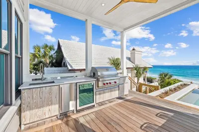 an outdoor kitchen with a view of the ocean at Del mar 30A in Seacrest