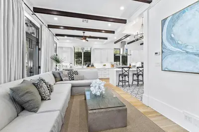 a living room with a couch and a table at Abba Cottage & Carriage House in Rosemary Beach