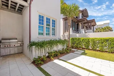 a house with a backyard with a grill at Devonshire West in Seacrest