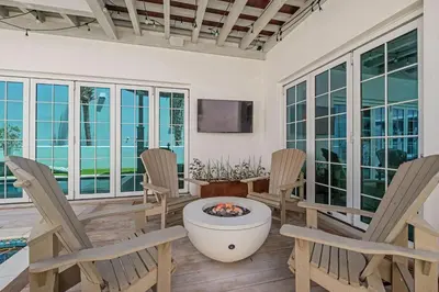 a living room with chairs and a fire pit at Devonshire West in Seacrest