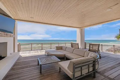 a living room with a couch and a view of the ocean at Devonshire West in Seacrest