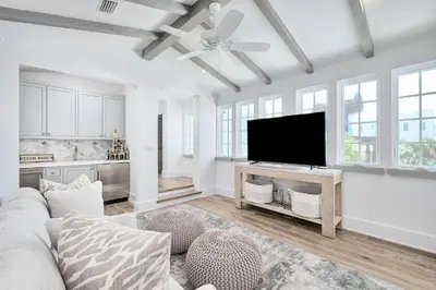 a living room with a couch and a flat screen tv at Devonshire West in Seacrest