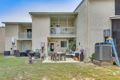 a house with a patio and a grill in the yard at The Wave PCB Townhome with Pools and Beach Access in Panama City Beach