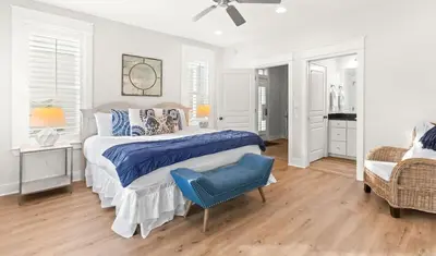 a bedroom with a bed and a blue chair at 17 Trigger Trail West in Panama City