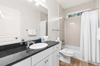a white bathroom with a sink and a toilet at 17 Trigger Trail West in Panama City