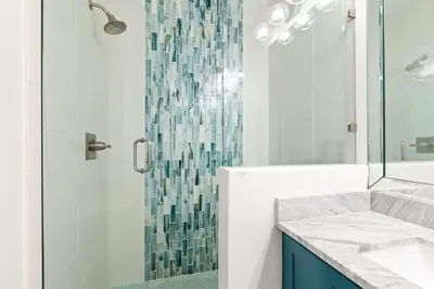 a bathroom with a glass shower and a sink at 17 Trigger Trail West in Panama City