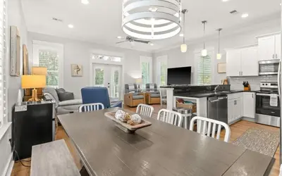 a kitchen and living room with a table and chairs at 17 Trigger Trail West in Panama City