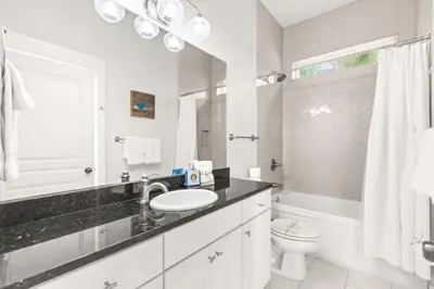 a white bathroom with a sink and a toilet at 17 Trigger Trail West in Panama City