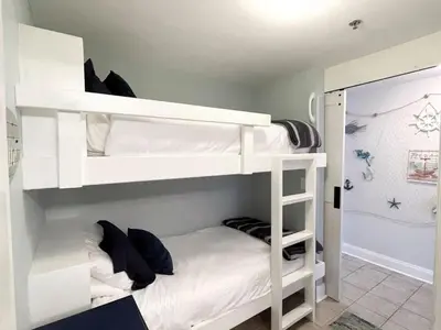 a bedroom with two bunk beds in a room at Laketown Wharf 1817 in Panama City Beach