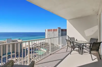 a balcony with a table and chairs and the ocean at Laketown Wharf 1817 in Panama City Beach