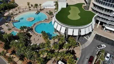 an aerial view of a resort pool with a golf course at Laketown Wharf 1817 in Panama City Beach