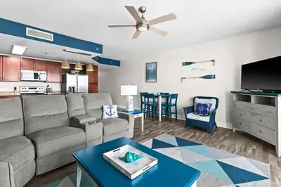 a living room with a couch and a table at Laketown Wharf 1817 in Panama City Beach