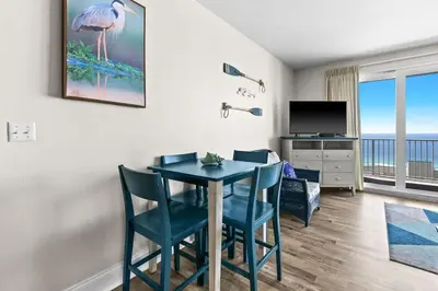 a dining room with a table and chairs and a television at Laketown Wharf 1817 in Panama City Beach