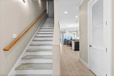 an open hallway with stairs in a house at Blessing on the Beach in Panama City Beach