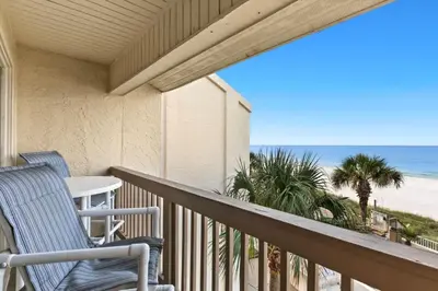 a balcony with two chairs and a view of the beach at Latitude 29 Unit 21 in Panama City Beach