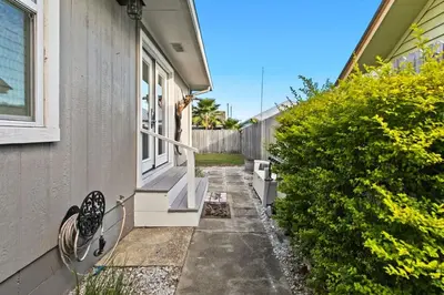 a side walk to a house with a window at Sandy Feet Escape in Panama City Beach