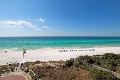 a view of a beach with a flag and the ocean at One Seagrove Place 0601 in Santa Rosa Beach