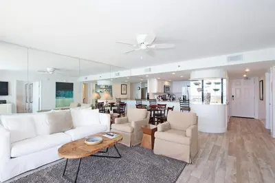 a living room with a white couch and a table at One Seagrove Place 0601 in Santa Rosa Beach