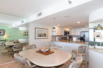 a kitchen and dining room with a table and chairs at One Seagrove Place 0605 in Santa Rosa Beach