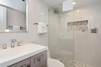 a white bathroom with a sink and a shower at One Seagrove Place 0806 in Santa Rosa Beach