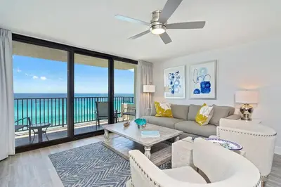 a living room with a couch and chairs and a balcony at One Seagrove Place 0806 in Santa Rosa Beach
