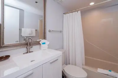 a bathroom with a sink and a toilet and a mirror at One Seagrove Place 0501 in Santa Rosa Beach