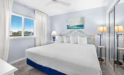 a bedroom with a white bed and a window at One Seagrove Place 0501 in Santa Rosa Beach