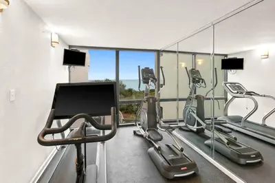 a gym with treadmills and elliptical machines at One Seagrove Place 0501 in Santa Rosa Beach
