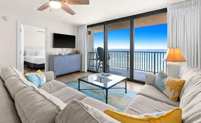 a living room with a couch and a view of the ocean at One Seagrove Place 0604 in Santa Rosa Beach