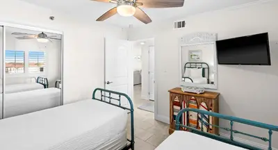 a bedroom with two beds and a flat screen tv at One Seagrove Place 0604 in Santa Rosa Beach