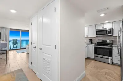 a kitchen with white cabinets and a view of the ocean at One Seagrove Place 0604 in Santa Rosa Beach