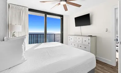 a bedroom with a white bed and a large window at One Seagrove Place 0802 in Santa Rosa Beach