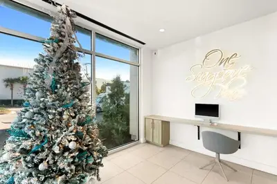 a christmas tree in a room with a desk at One Seagrove Place 0802 in Santa Rosa Beach