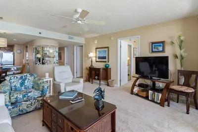 a living room with a couch and a tv at One Seagrove Place 1007 in Santa Rosa Beach