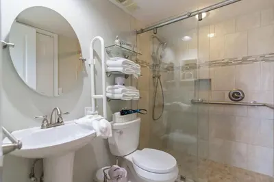 a bathroom with a shower and a toilet and a sink at One Seagrove Place 1007 in Santa Rosa Beach
