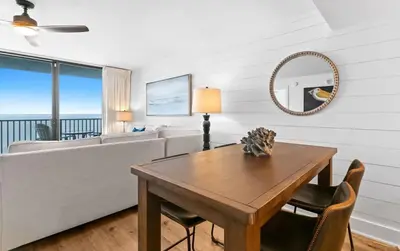 a living room with a couch and a table at One Seagrove Place 0906 in Santa Rosa Beach