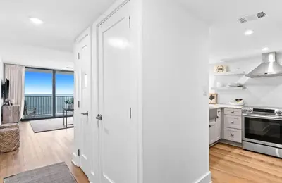 a kitchen with white cabinets and a view of the ocean at One Seagrove Place 0906 in Santa Rosa Beach