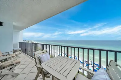 a balcony with chairs and a view of the beach at One Seagrove Place 1102 in Santa Rosa Beach