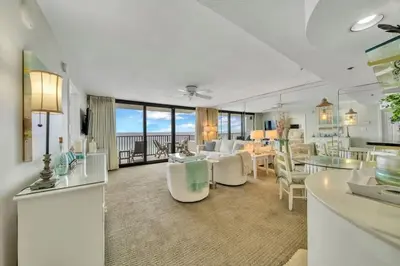 a living room with a couch and a dining room at One Seagrove Place 1102 in Santa Rosa Beach